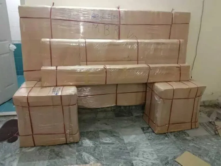 Packed household goods stacked against a wall, ready to move